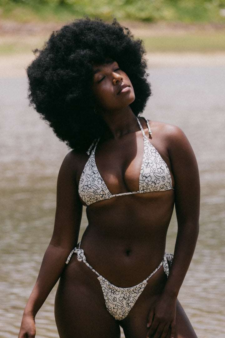 Model standing in water wearing Hawaiian Cream bikini